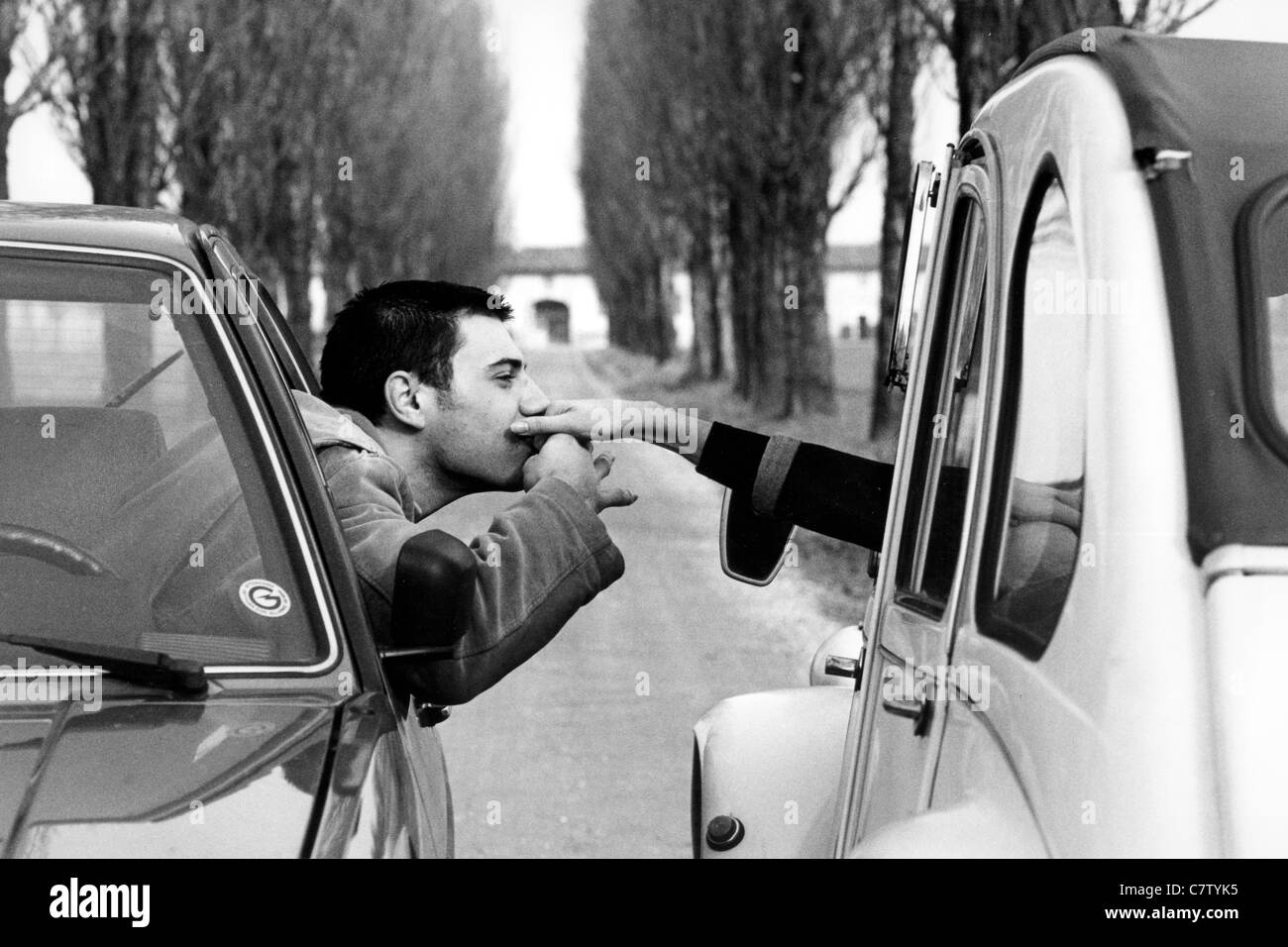 Young man and woman in two different cars Stock Photo