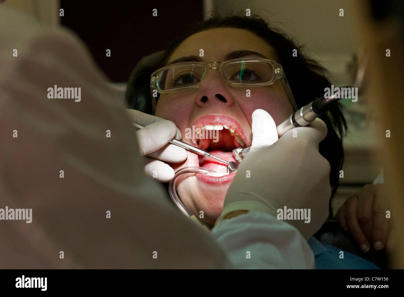 Dentist examining female patient Stock Photo