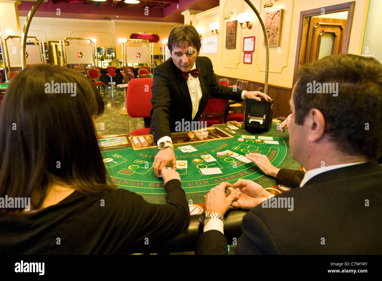 Italy, Val D'Aosta, Saint Vincent, croupier at poker table Stock Photo -  Alamy