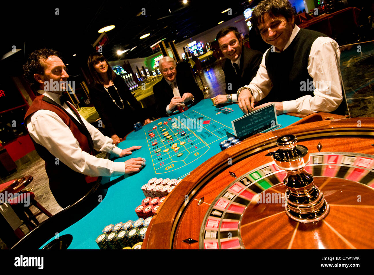 Italy, Val D\u0026#39;Aosta, Saint Vincent, people gambling at roulette table in ...