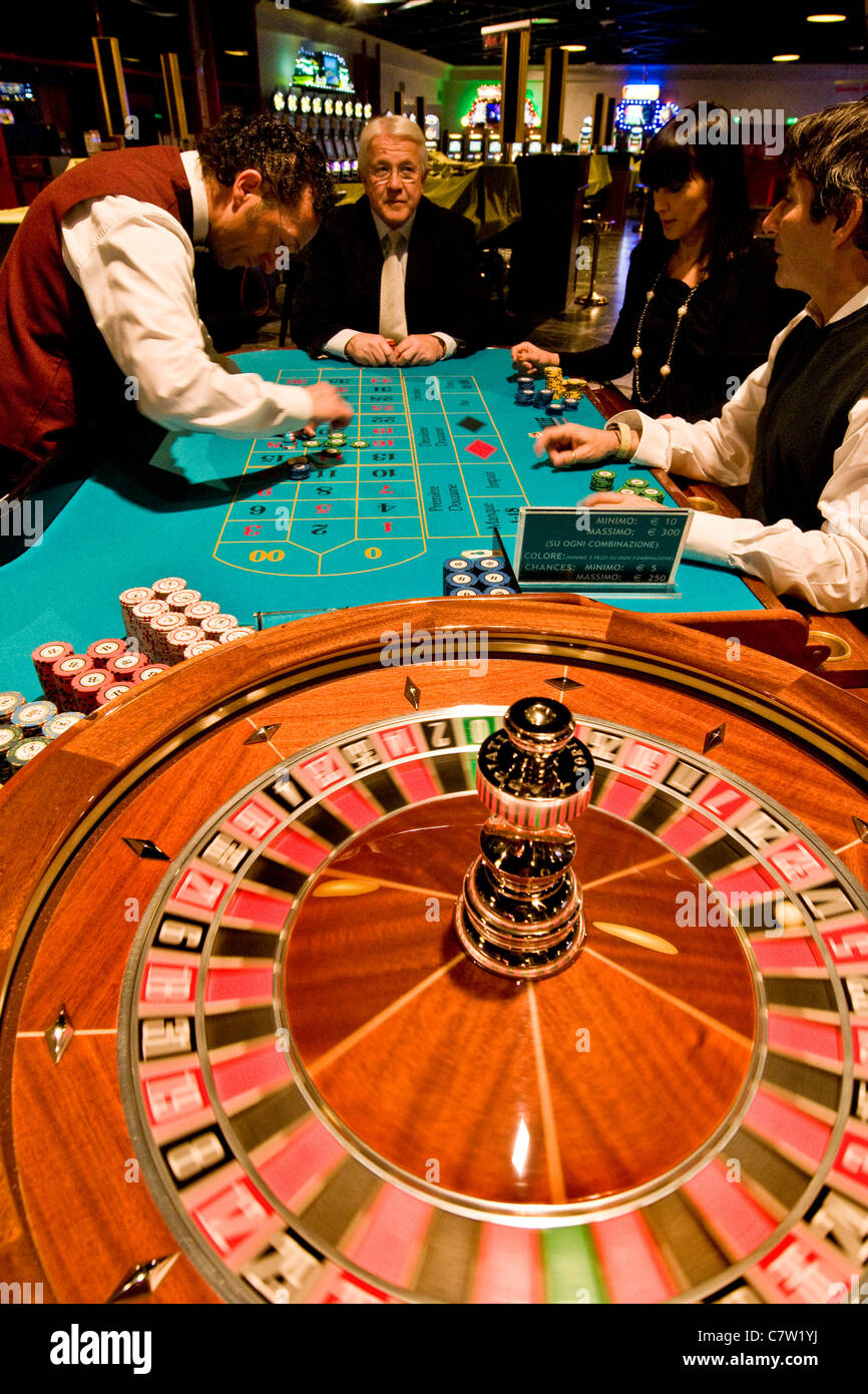 Italy, Val D'Aosta, Saint Vincent, people gambling at roulette table in ...