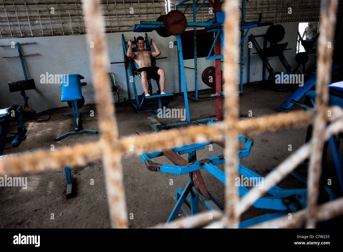 A young Cuban man trains at a bodybuilding gym in Alamar, a public housing complex in the Eastern Havana, Cuba. Stock Photo