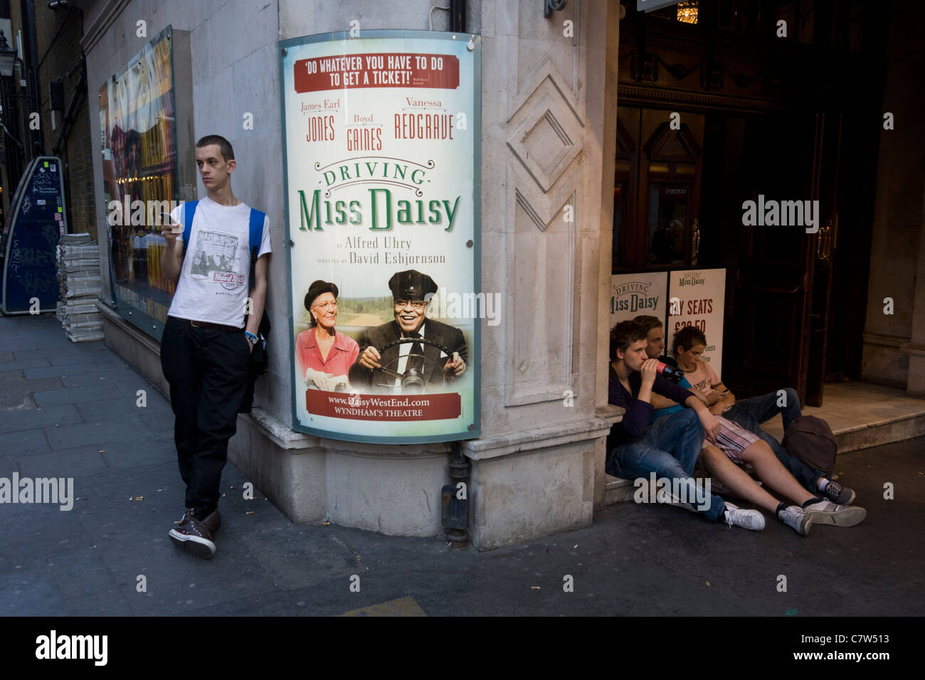 Youths hang around London's Wyndham's Theatre where the play 'Driving Miss Daisy' with Vanessa Redgrave is playing. Stock Photo