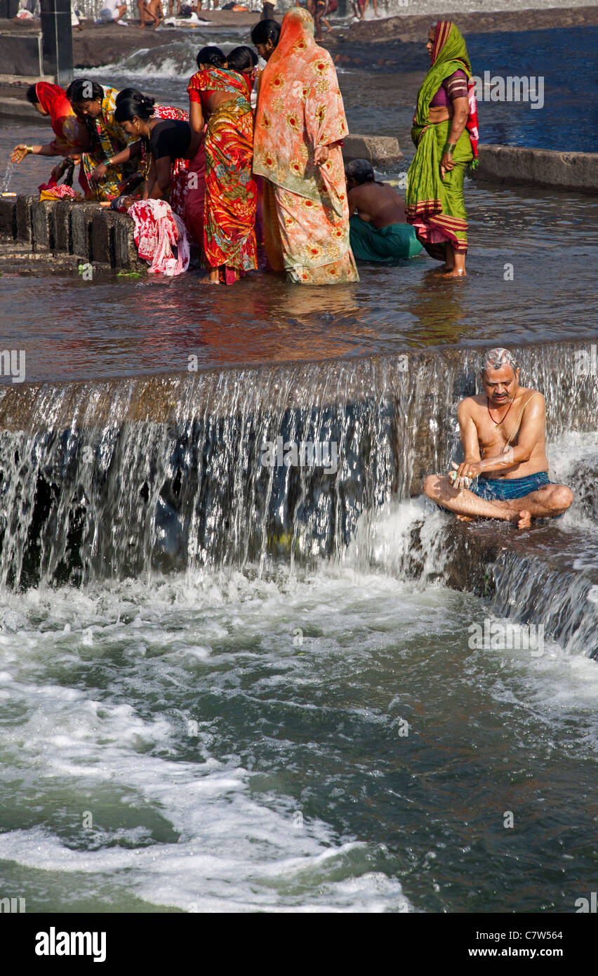 Man bathing in the sacred waters of the Godavari river. Ram Kund. Nasik. Maharastra state. India Stock Photo