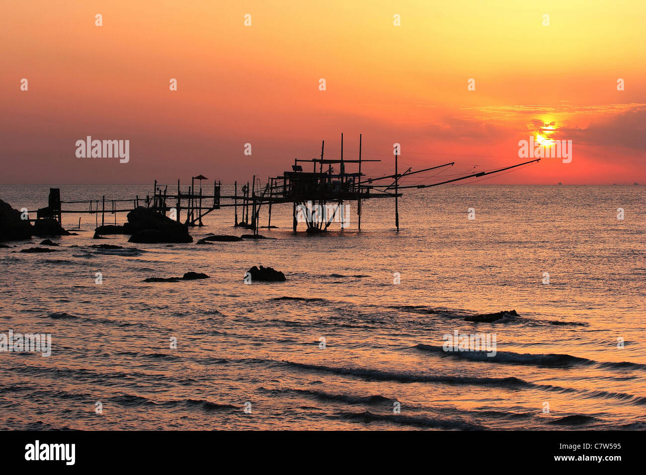 Italy, Abruzzo, Vasto, pier and fishing nets at sunset Stock Photo
