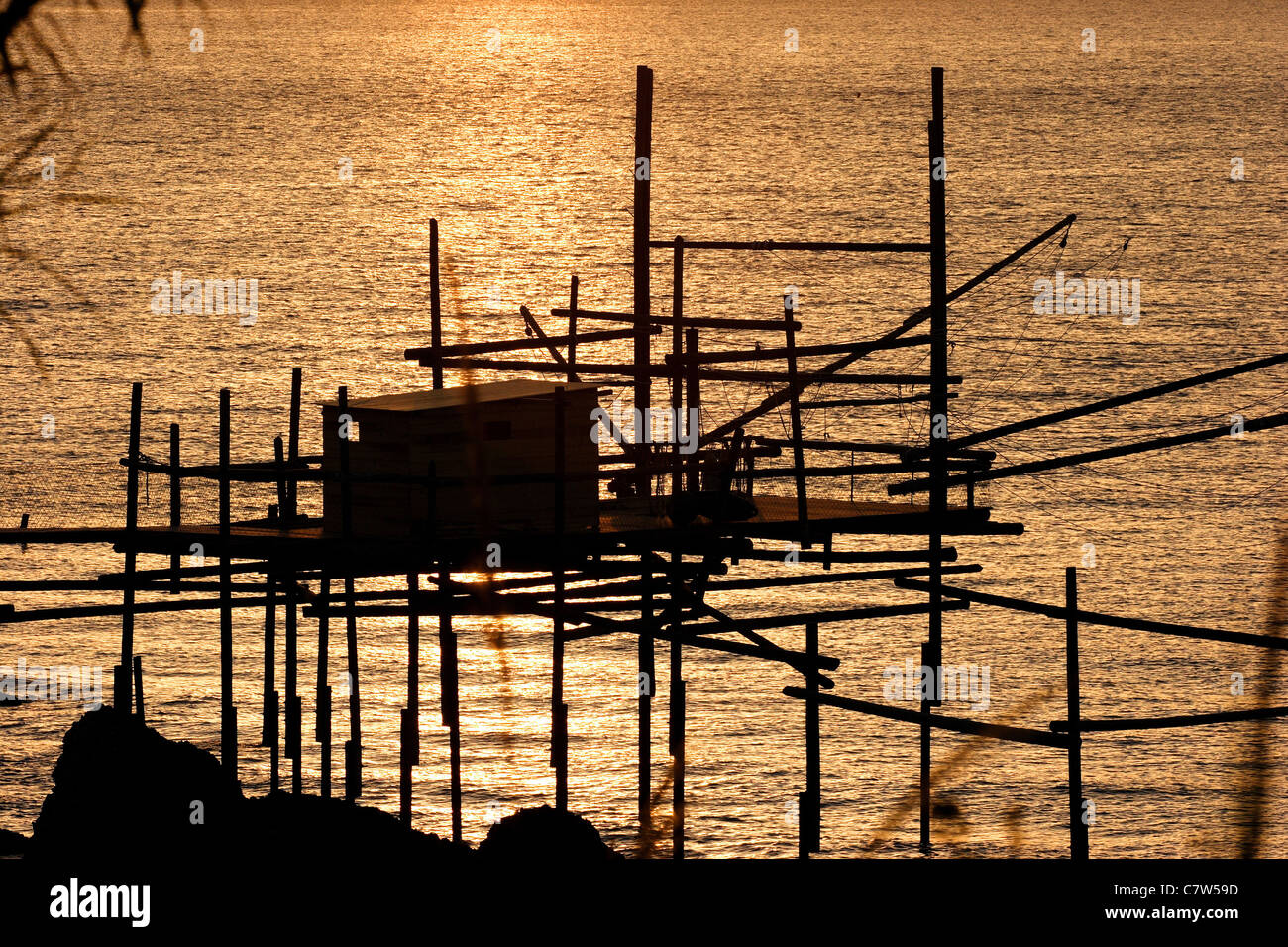Italy, Abruzzo, Vasto, pier and fishing nets at sunset Stock Photo