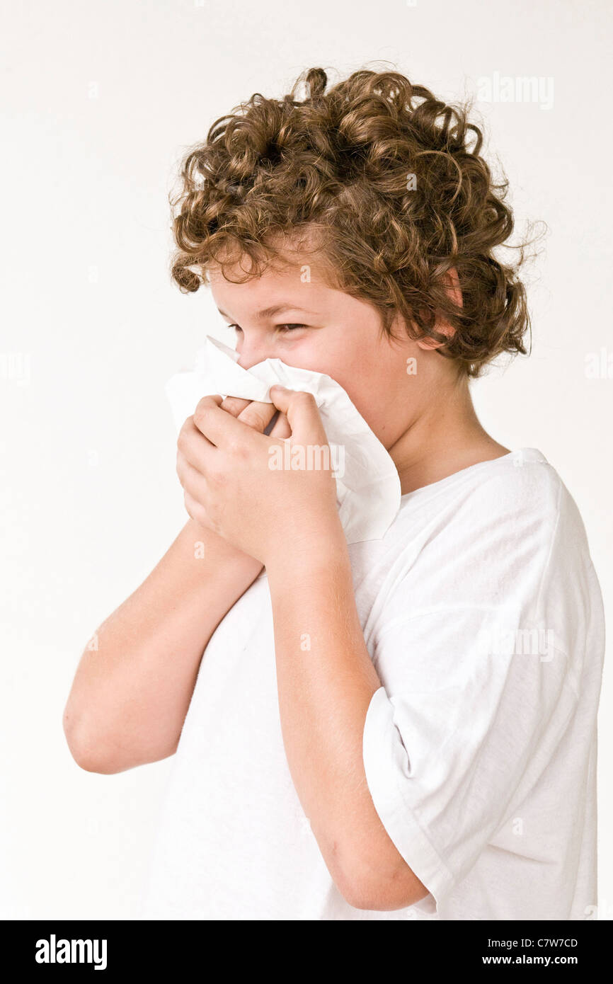 Boy blowing nose Stock Photo - Alamy