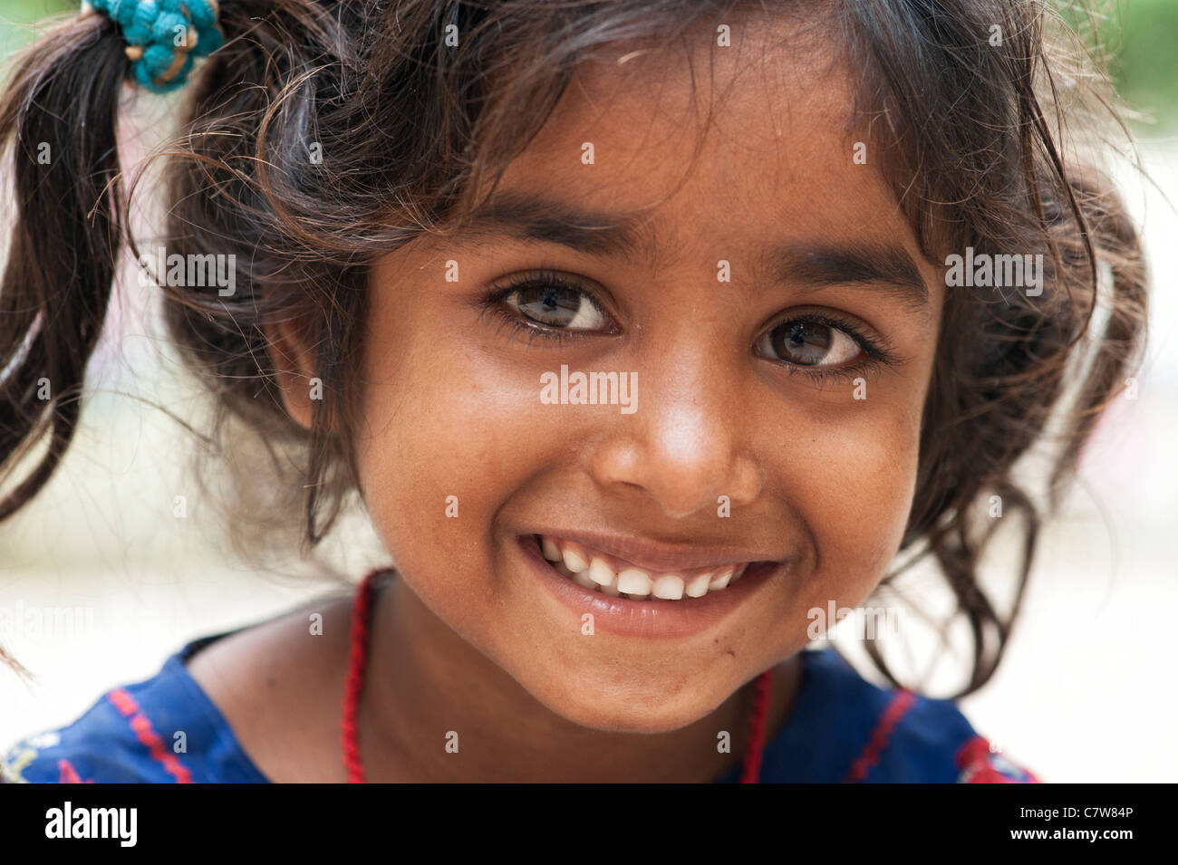 Young poor lower caste Indian street girl smiling Stock Photo