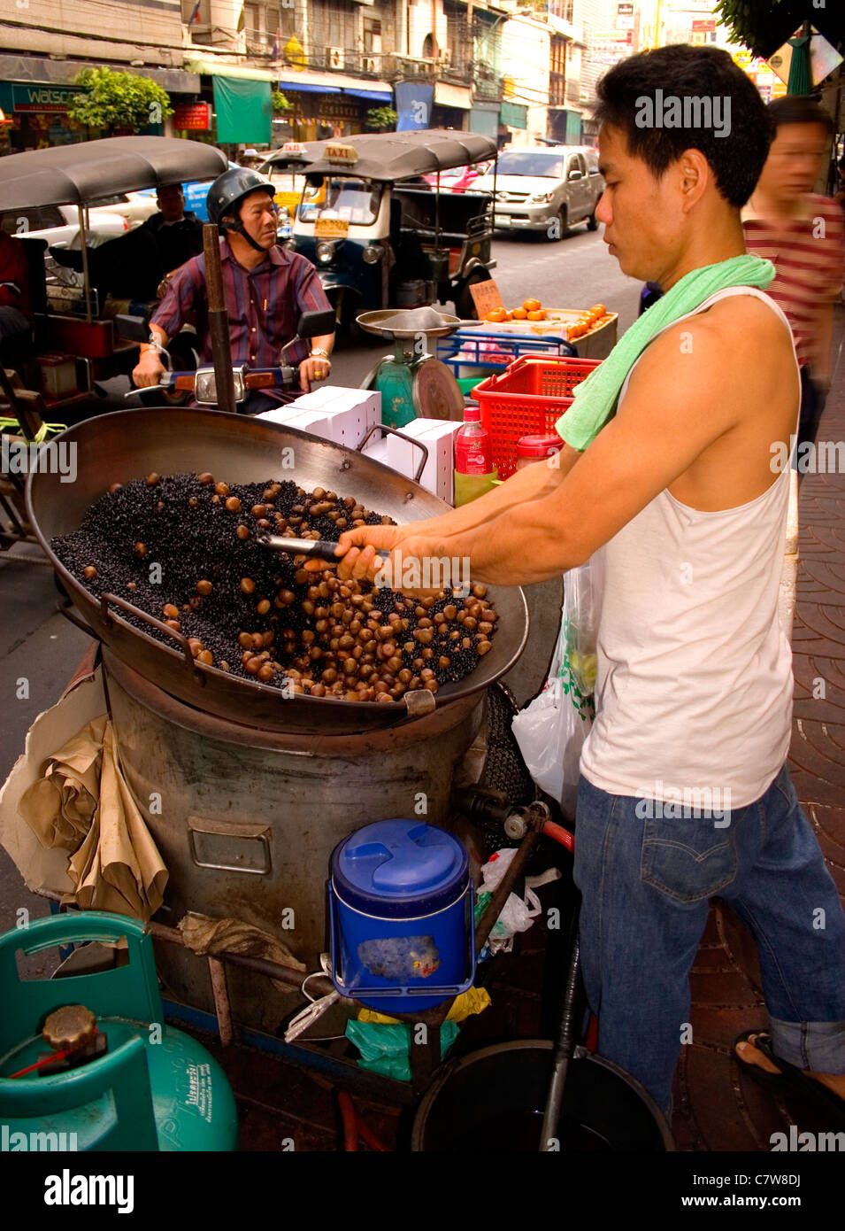Street vendor cooking chestnuts in Bangkok's China Town, Thailand. Stock Photo