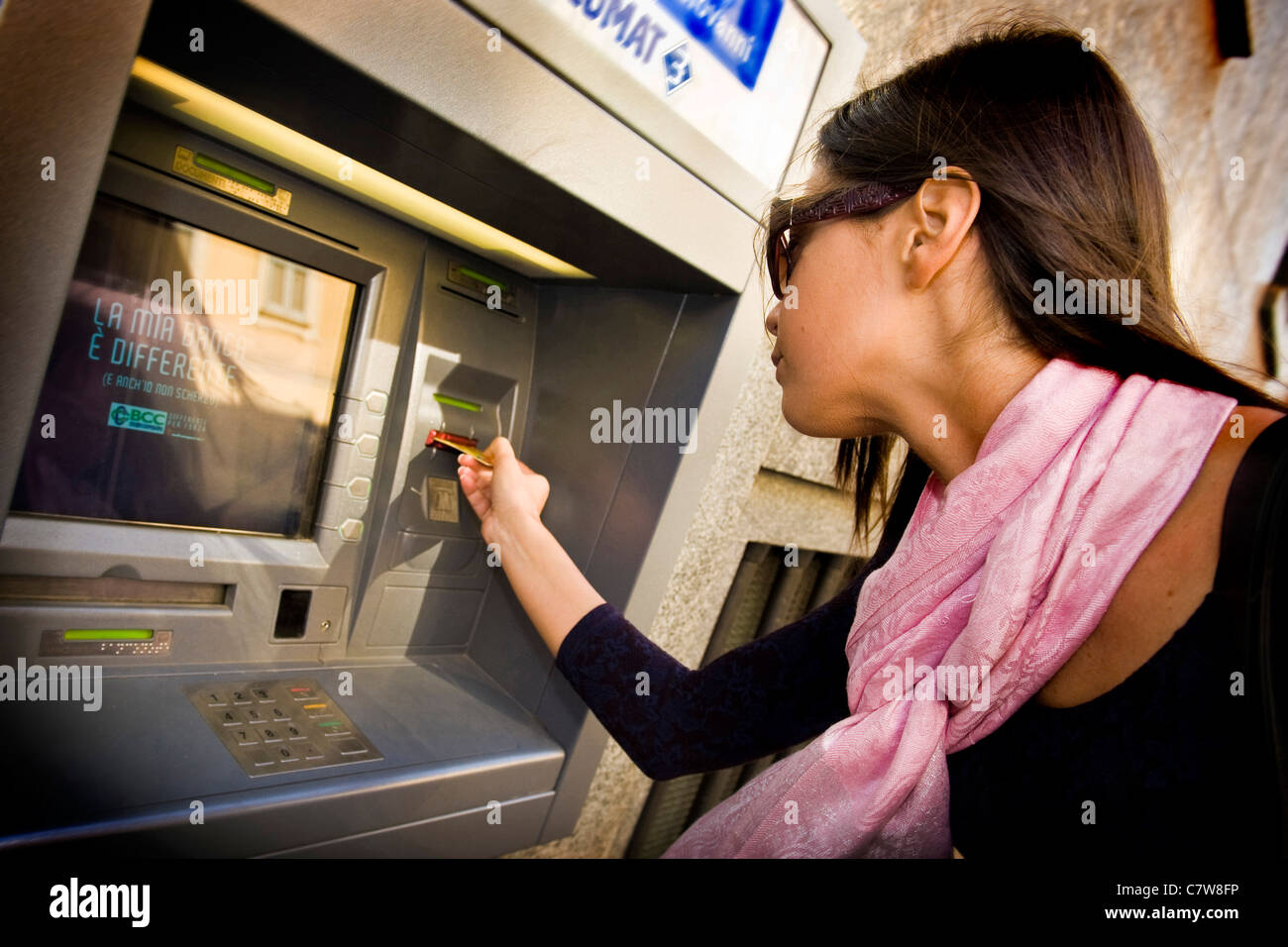Woman using an ATM machine Stock Photo