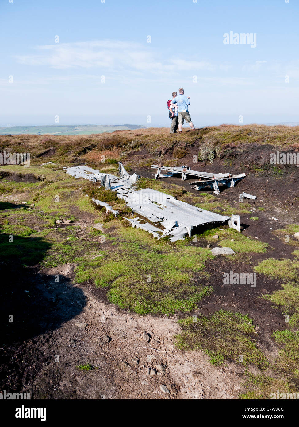 Two men discussing the wreck of a Liberator, Mill Hill, High Peak, Derbyshire, England, UK. Stock Photo