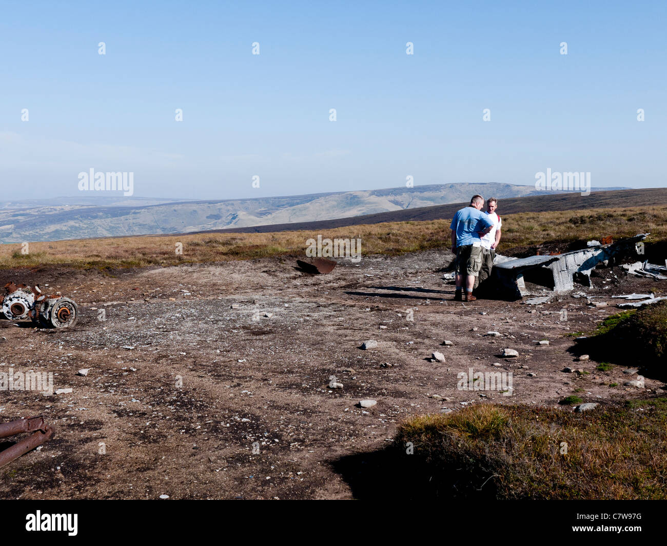 Two men discussing the wreck of a Liberator, Mill Hill, High Peak, Derbyshire, England, UK. Stock Photo