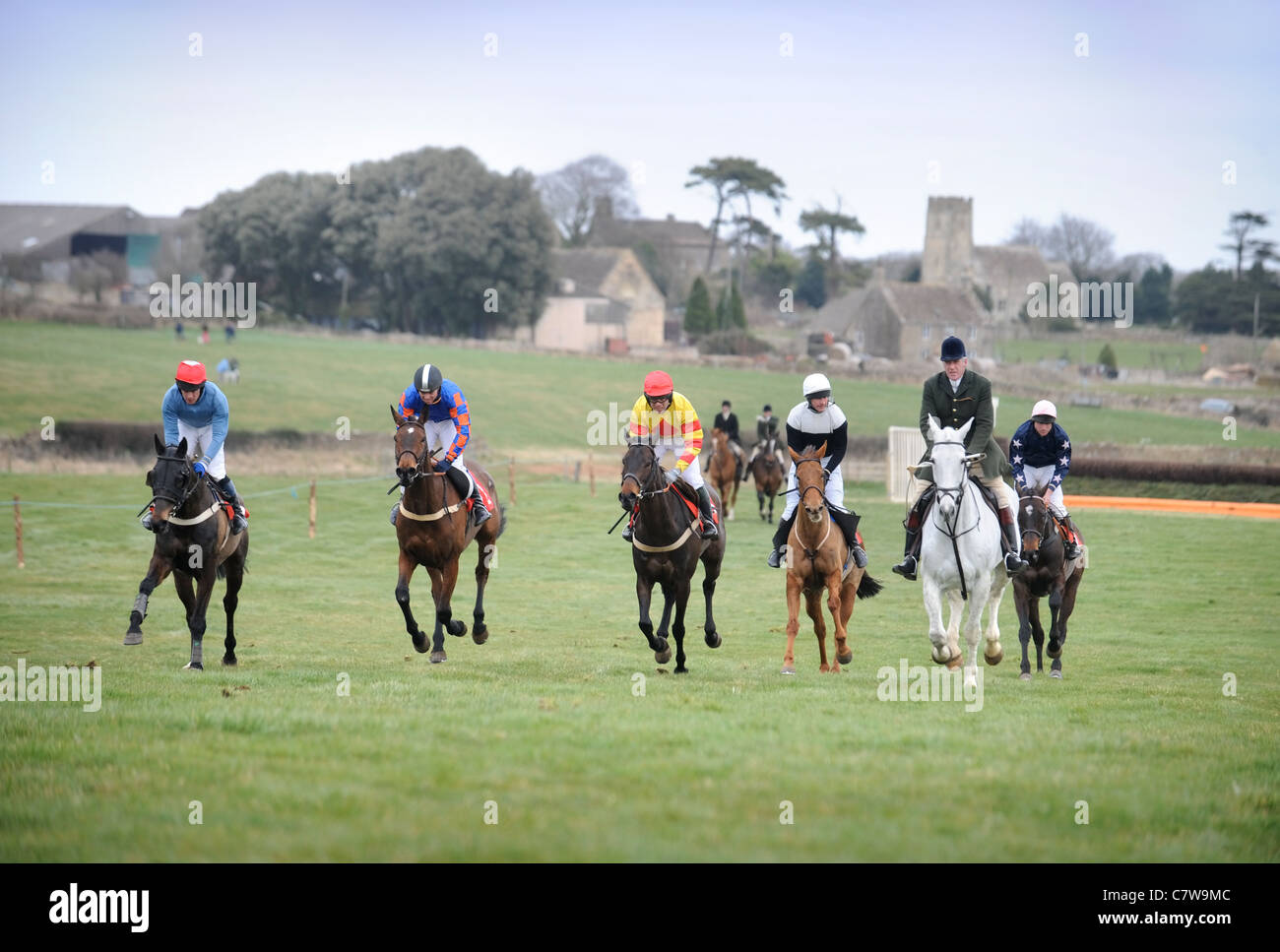 Sheknowsyouknow ridden by M. Wall (left, red diamond on silks) is escorted back after winning the Hunt members opening race at t Stock Photo