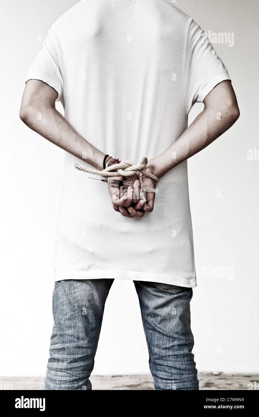 Hand holding syringe Stock Photo