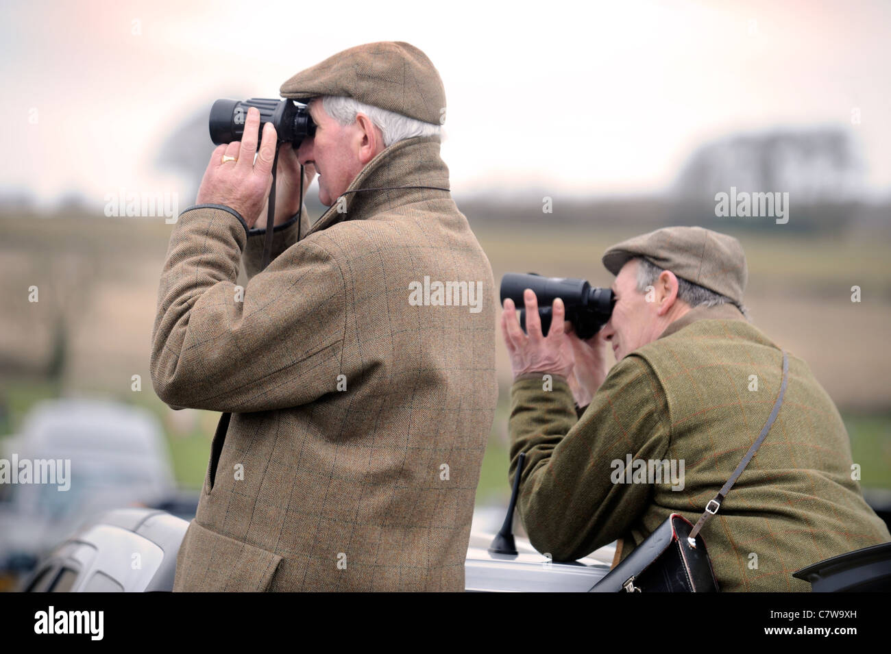 Two racegoers watch the action from the back of their estate car at the Duke of Beaufort's Hunt Point-to-Point 2009, Gloucesters Stock Photo