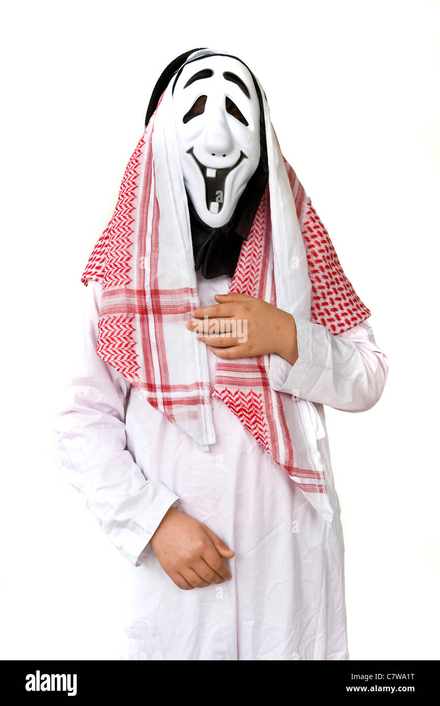 Studio shot of man dressed up as arab wearing Halloween mask Stock Photo