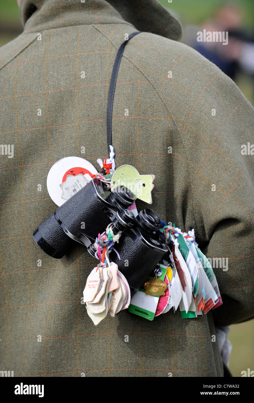 A horse racing enthusiasts binoculars with meeting badges attached UK Stock Photo