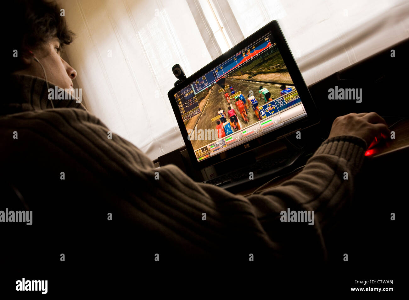 Man playing video game on computer home Stock Photo