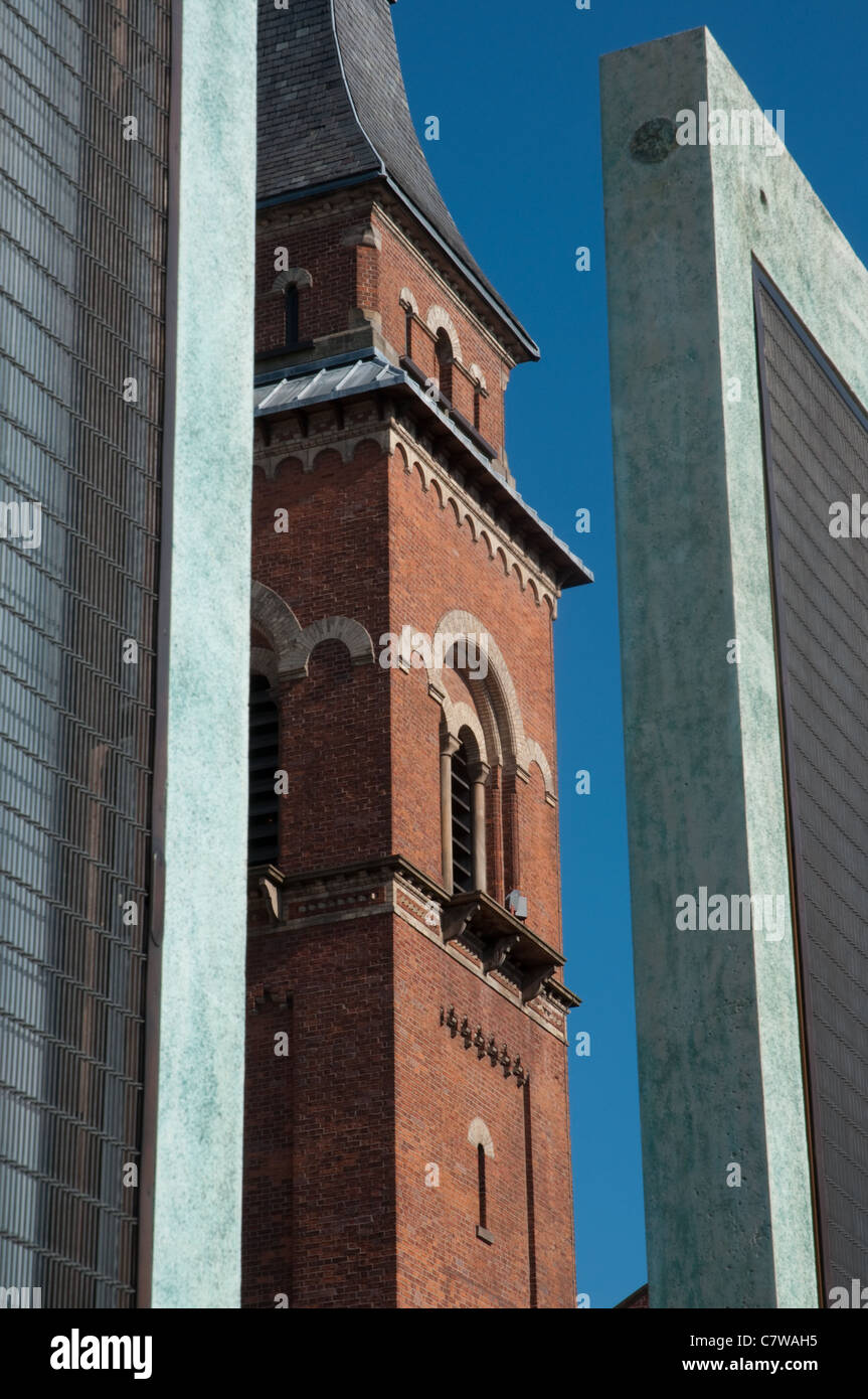 The bell tower of St Peter's church,Ancoats,Manchester.Viewed between two of the five sentinels created by artist Dan Dubowitz Stock Photo