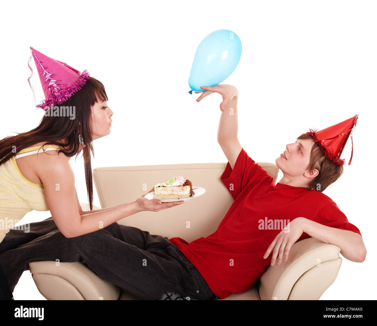 Man in party hat and girl eating cake. Stock Photo