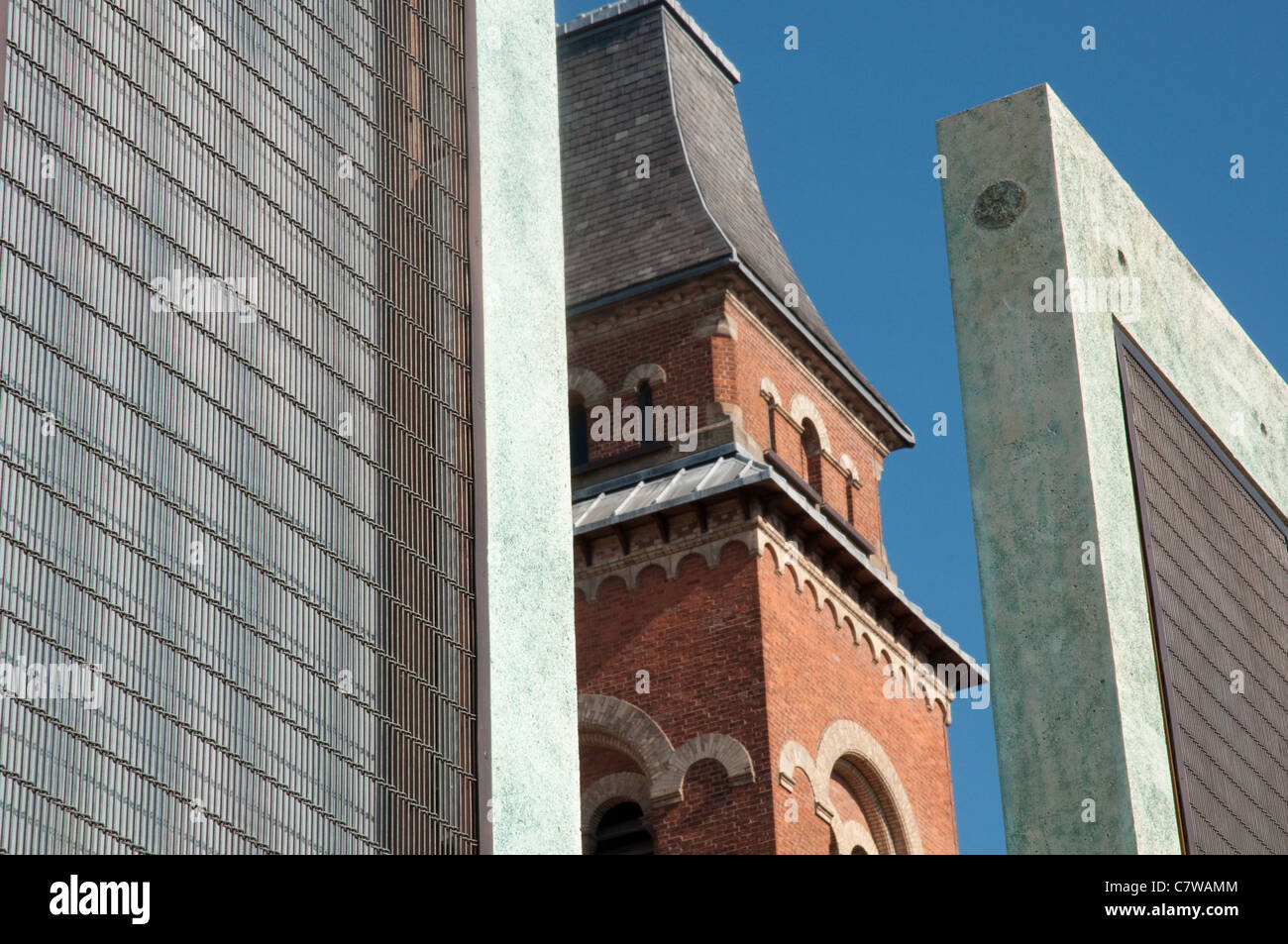 The bell tower of St Peter's church,Ancoats,Manchester.Viewed between two of the five sentinels created by artist Dan Dubowitz Stock Photo
