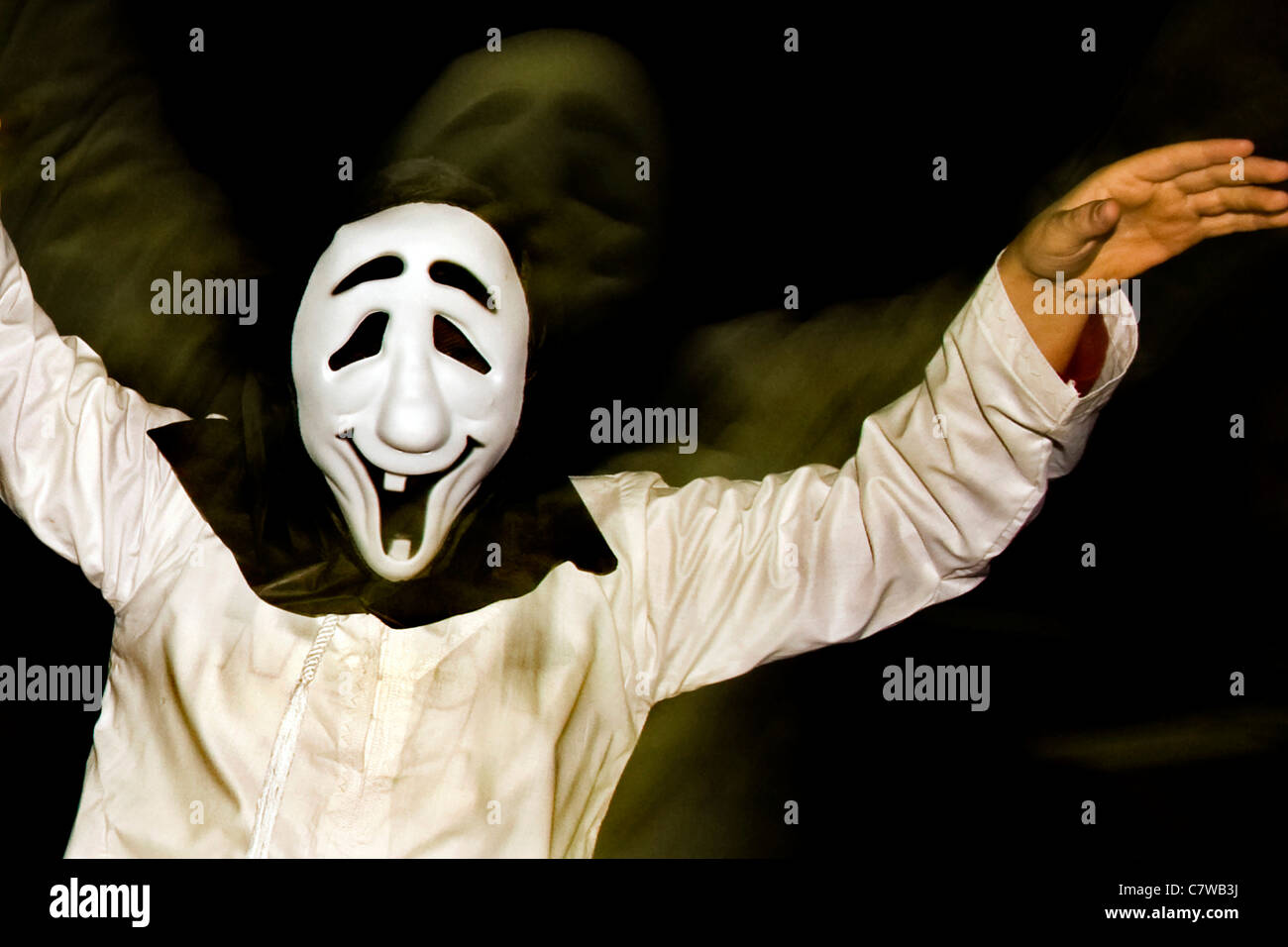 Studio shot of man dressed wearing Halloween mask Stock Photo