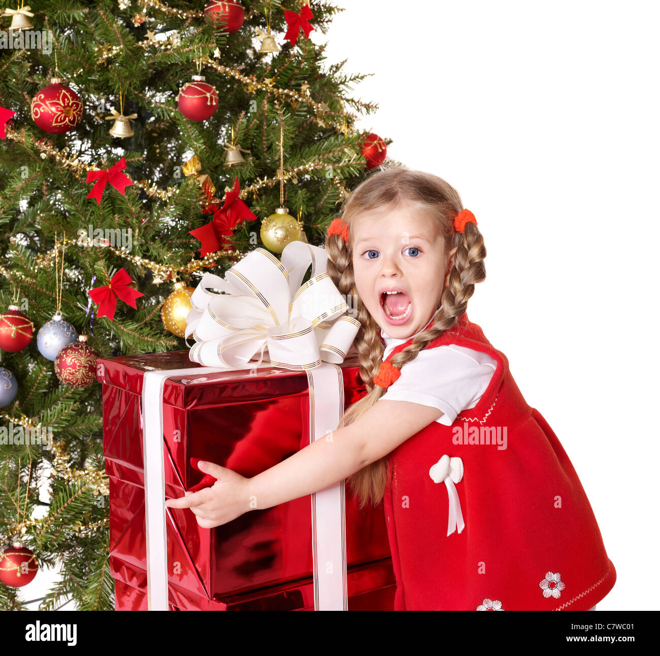 Child holding group gift box by Christmas tree Stock Photo - Alamy