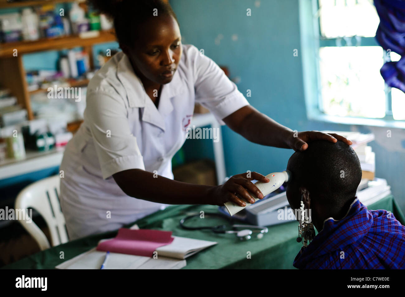 Nurse examining a Masai woman at a free medical clinic, Meserani, Tanzania. Stock Photo