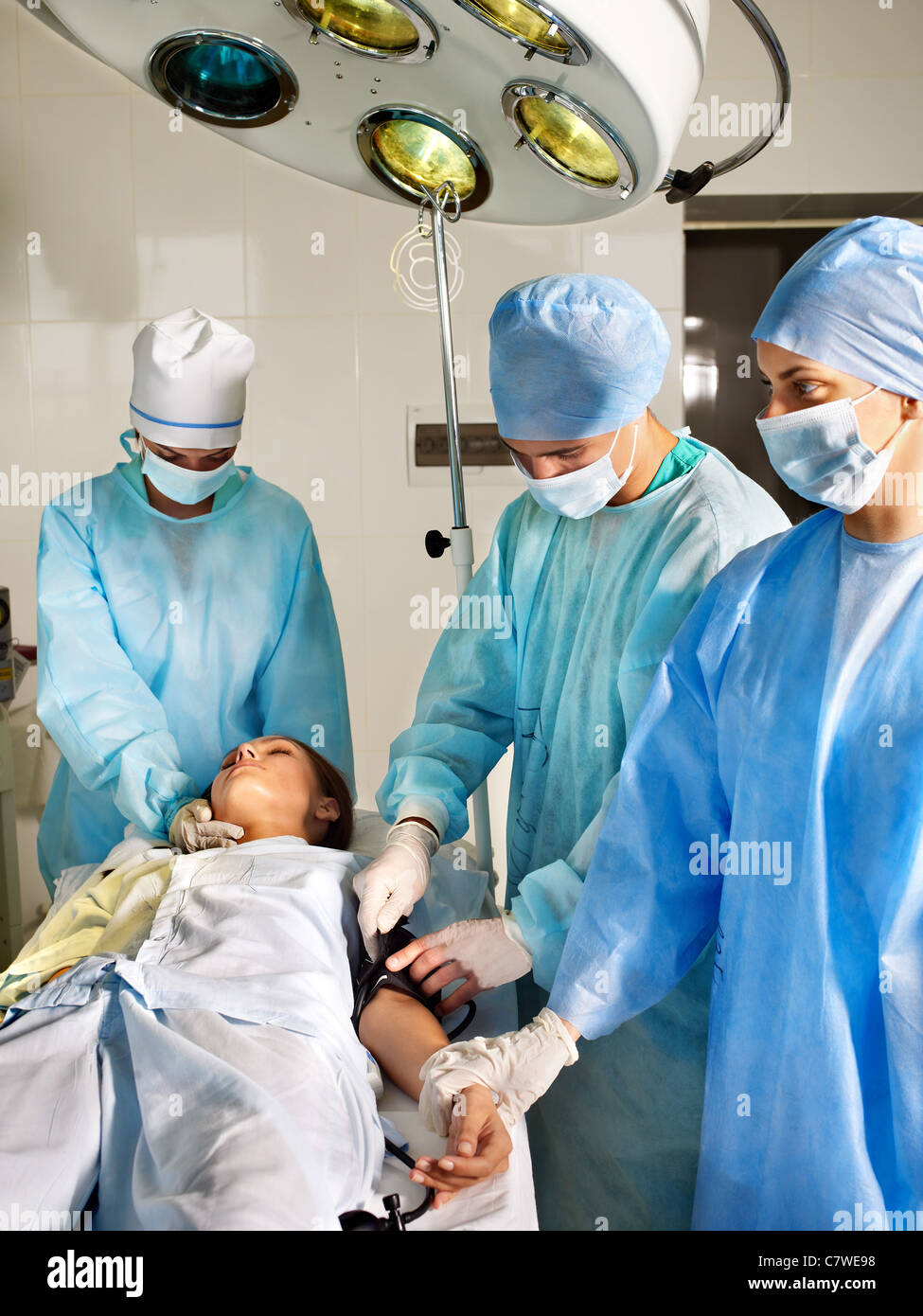 Group of surgeon looking at patient in operation room Stock Photo - Alamy