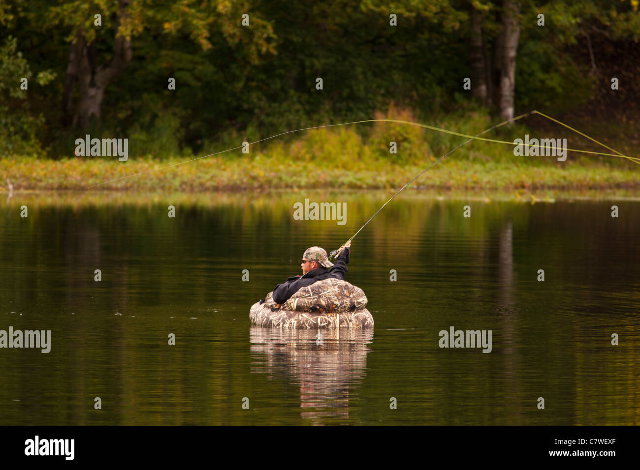 ANCHORAGE, ALASKA, USA Man fly fishing on pond in Kincaid Park Stock