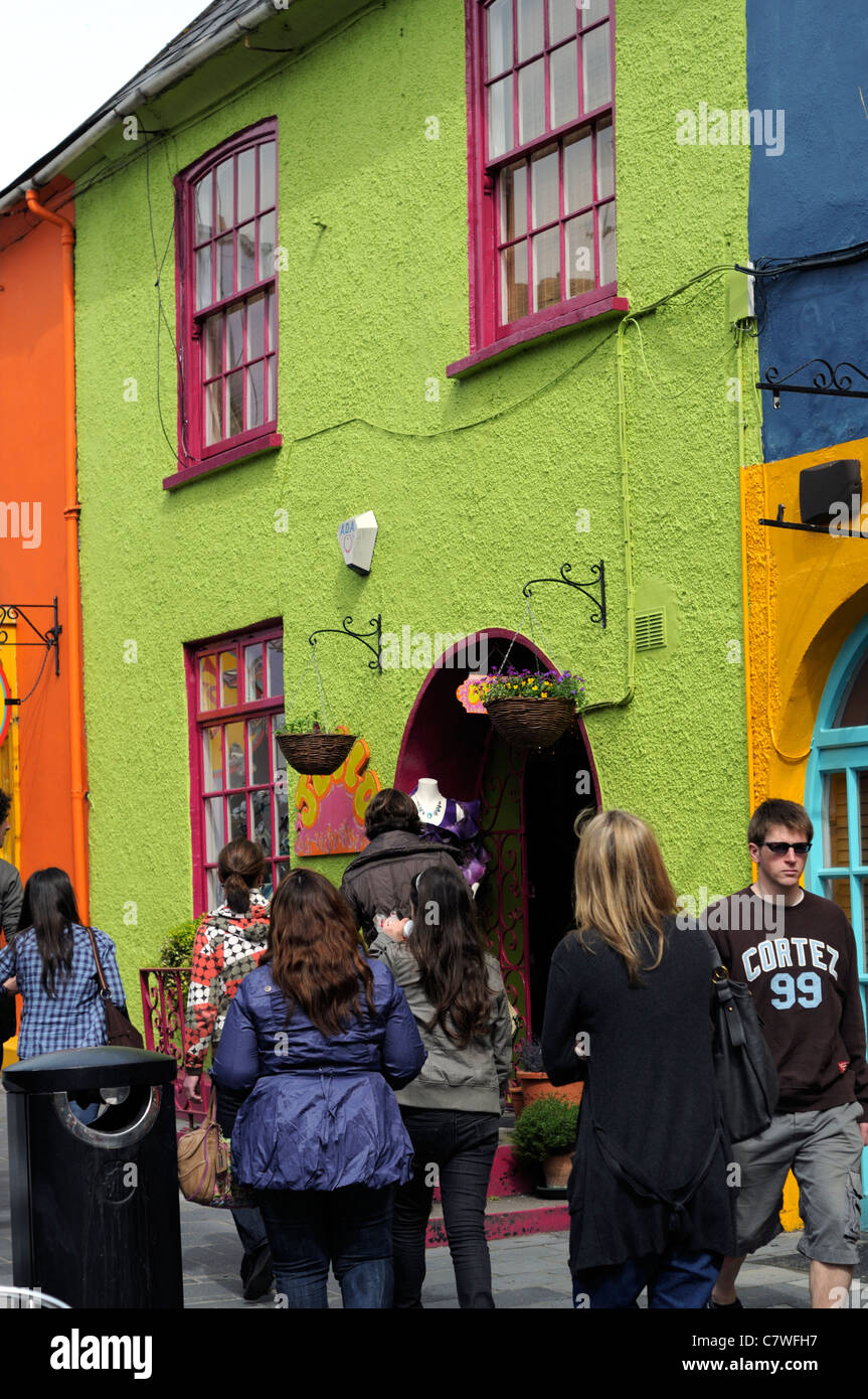 people walking shop shopping street scene kinsale cork ireland brightly coloured colored buildings shops Stock Photo