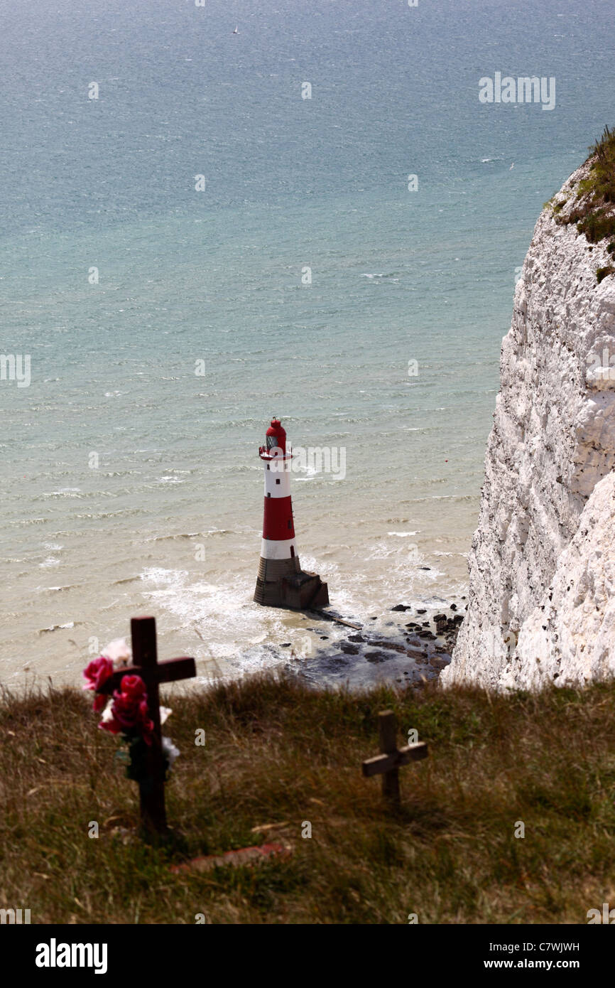 Crosses near Beachy Head and lighthouse ( focus on lighthouse ) , near Eastbourne , East Sussex , England . Stock Photo