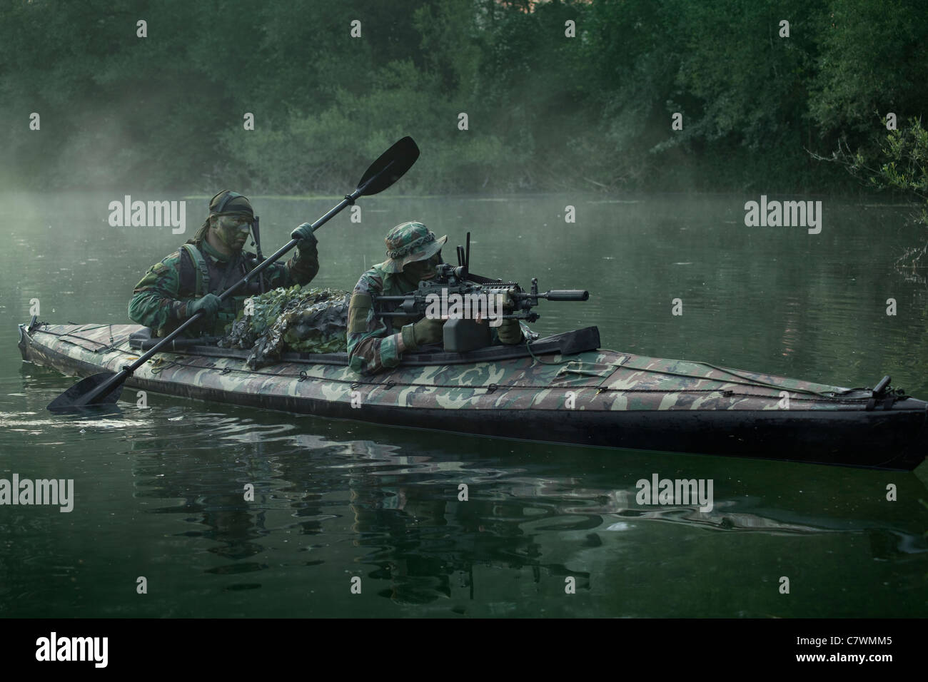 navy-seals-navigate-the-waters-in-a-folding-kayak-during-jungle-warfare-C7WMM5.jpg