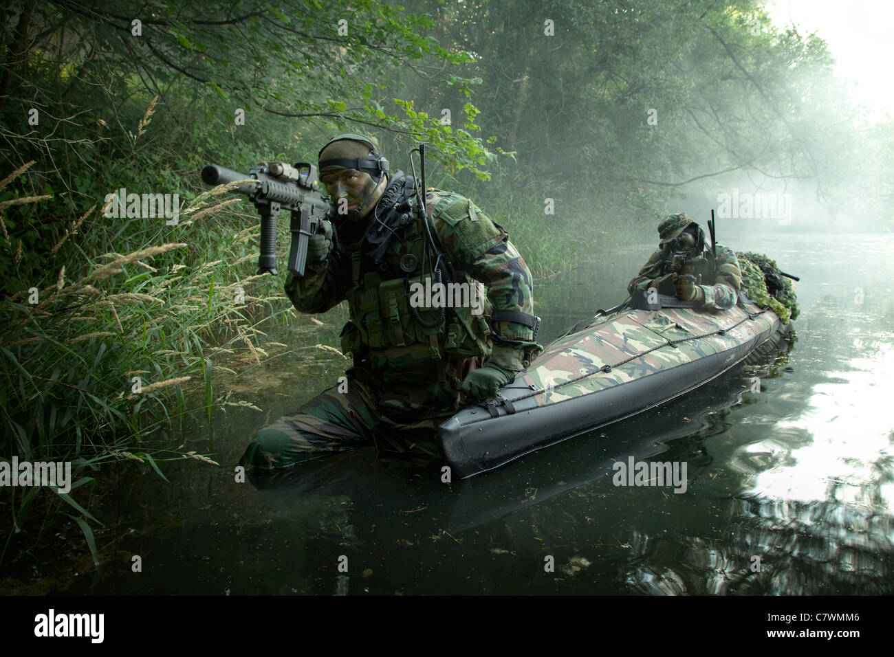 Navy SEALs navigate the waters in a folding kayak during jungle warfare