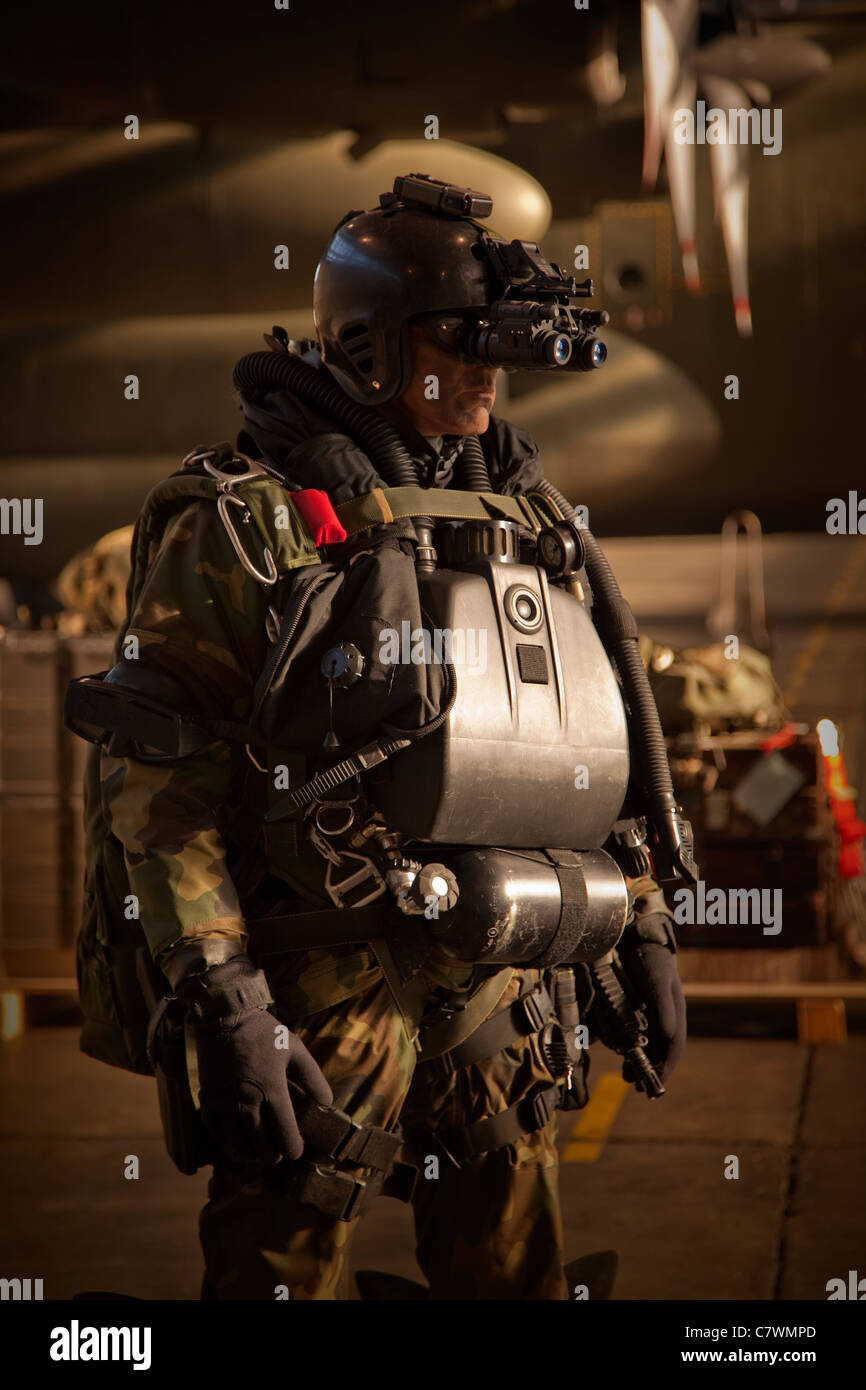 U.S. Navy Seal combat diver equipped with night vision, prepares for HALO jump operations from a C-130 Hercules. Stock Photo