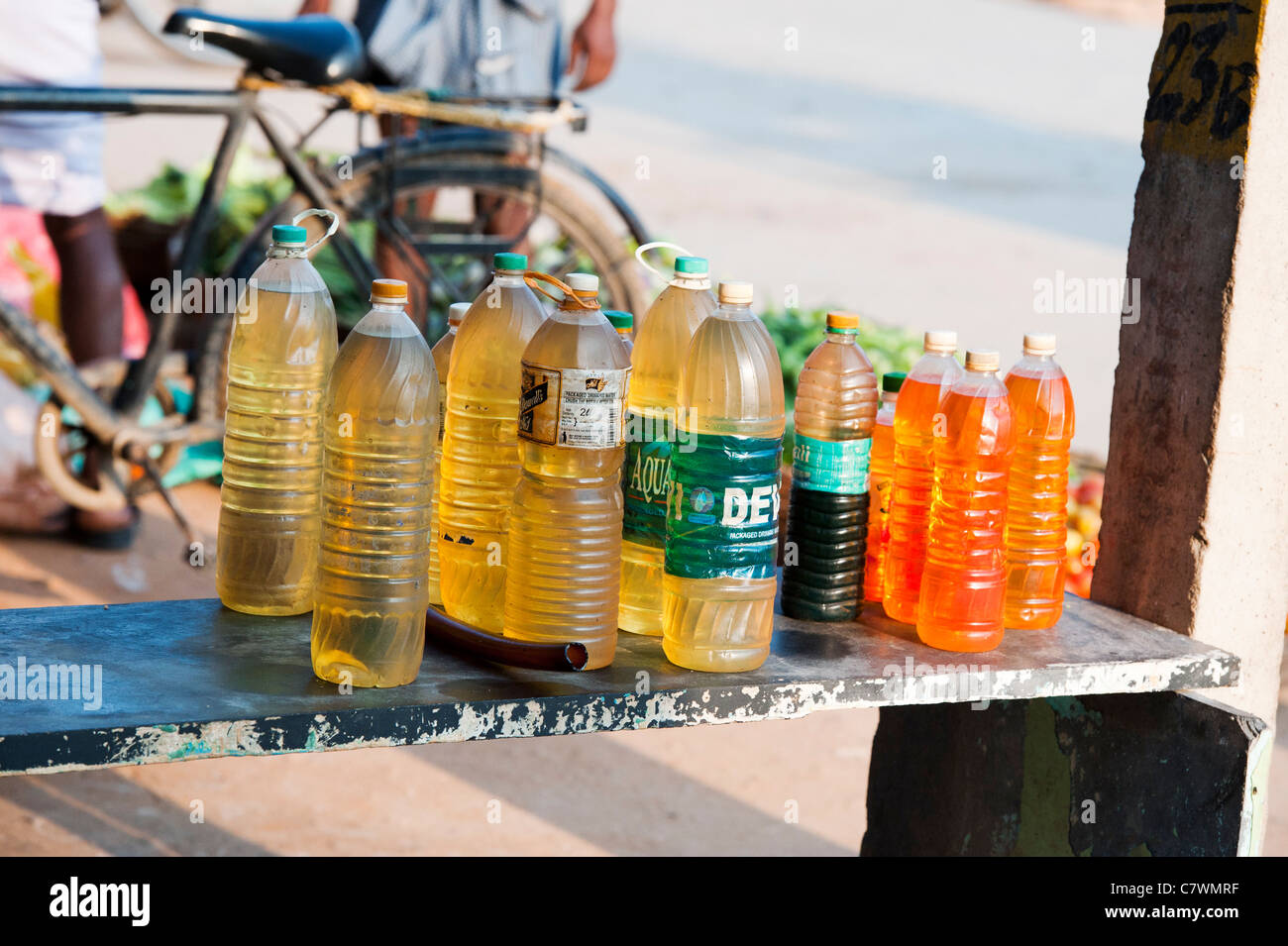 Indian petrol sold in plastic bottles outside a shop. Puttaparthi, Andhra Pradesh, India Stock Photo