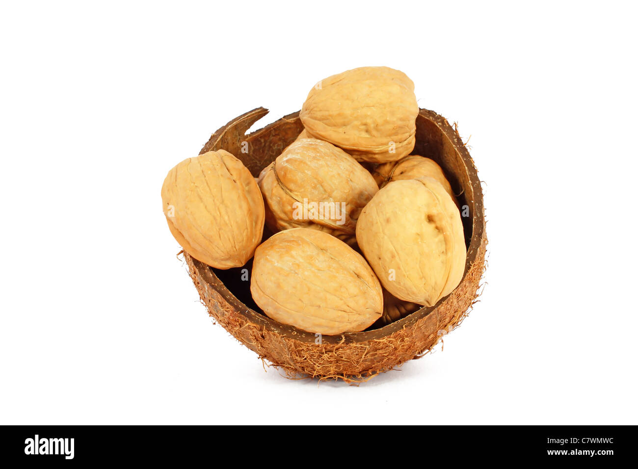 Walnuts in coco shell isolated on white Stock Photo