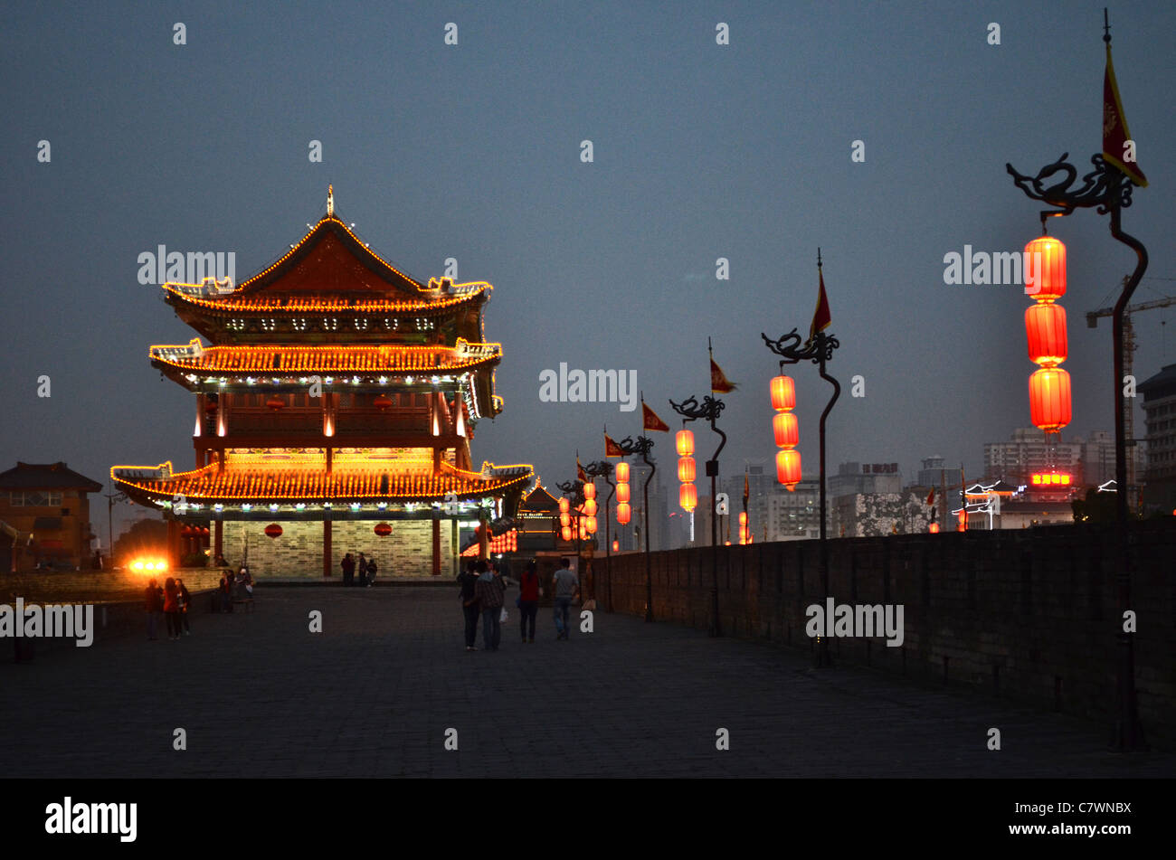 Buildings and lanterns light up at nightfall on the city walls of Xi'an