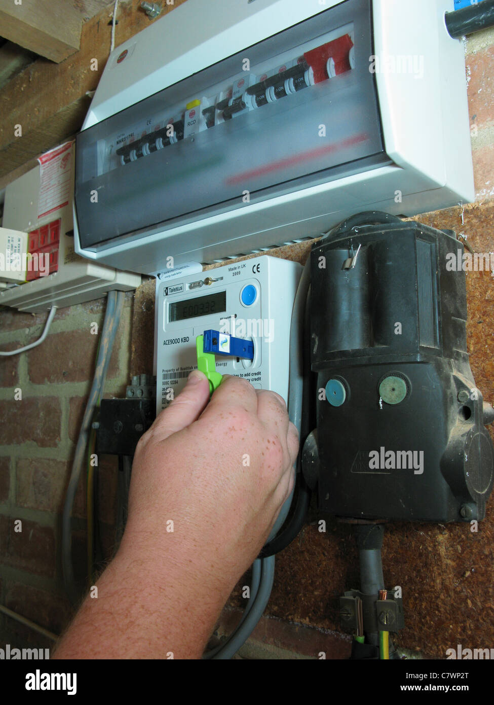 man using a quantum key prepayment electric meter, paying for