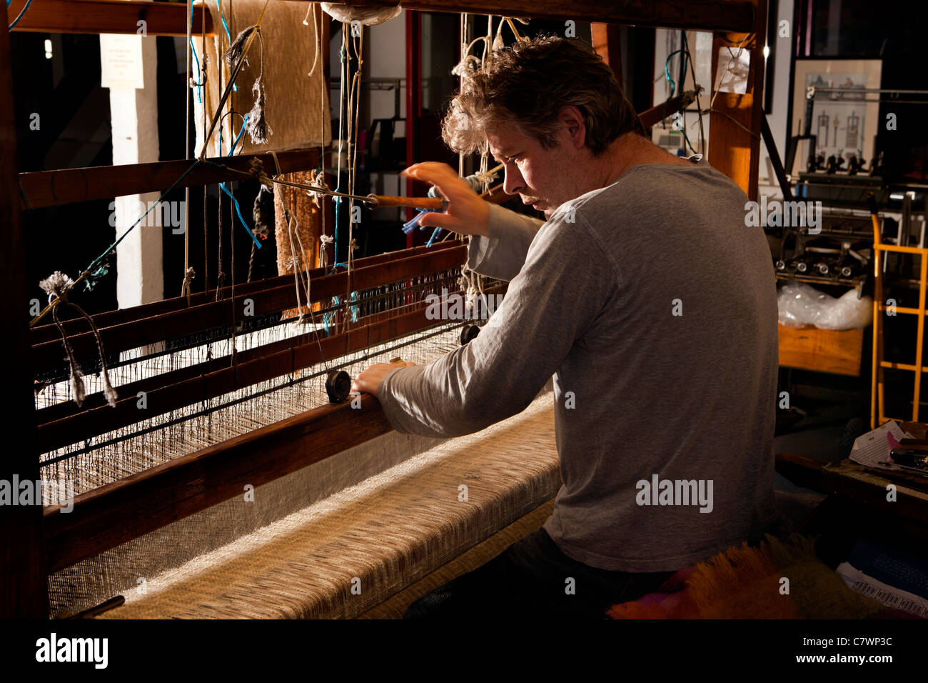 Ireland, Co Wicklow, Avoca Handweavers Mill, weaver weaving cloth on