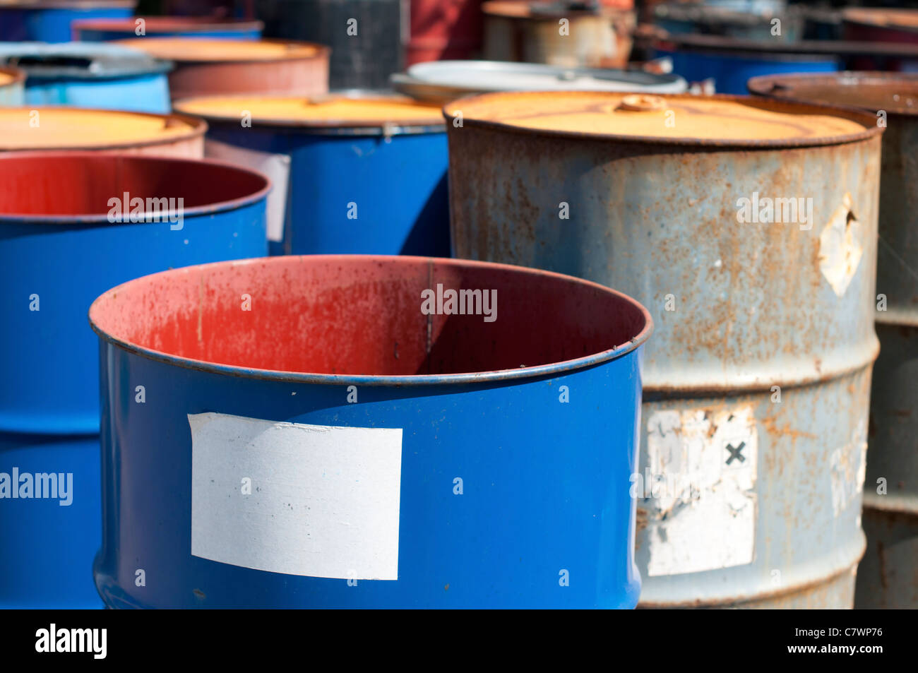 Old colored barrels for oil products. Empty rusted drums Stock Photo