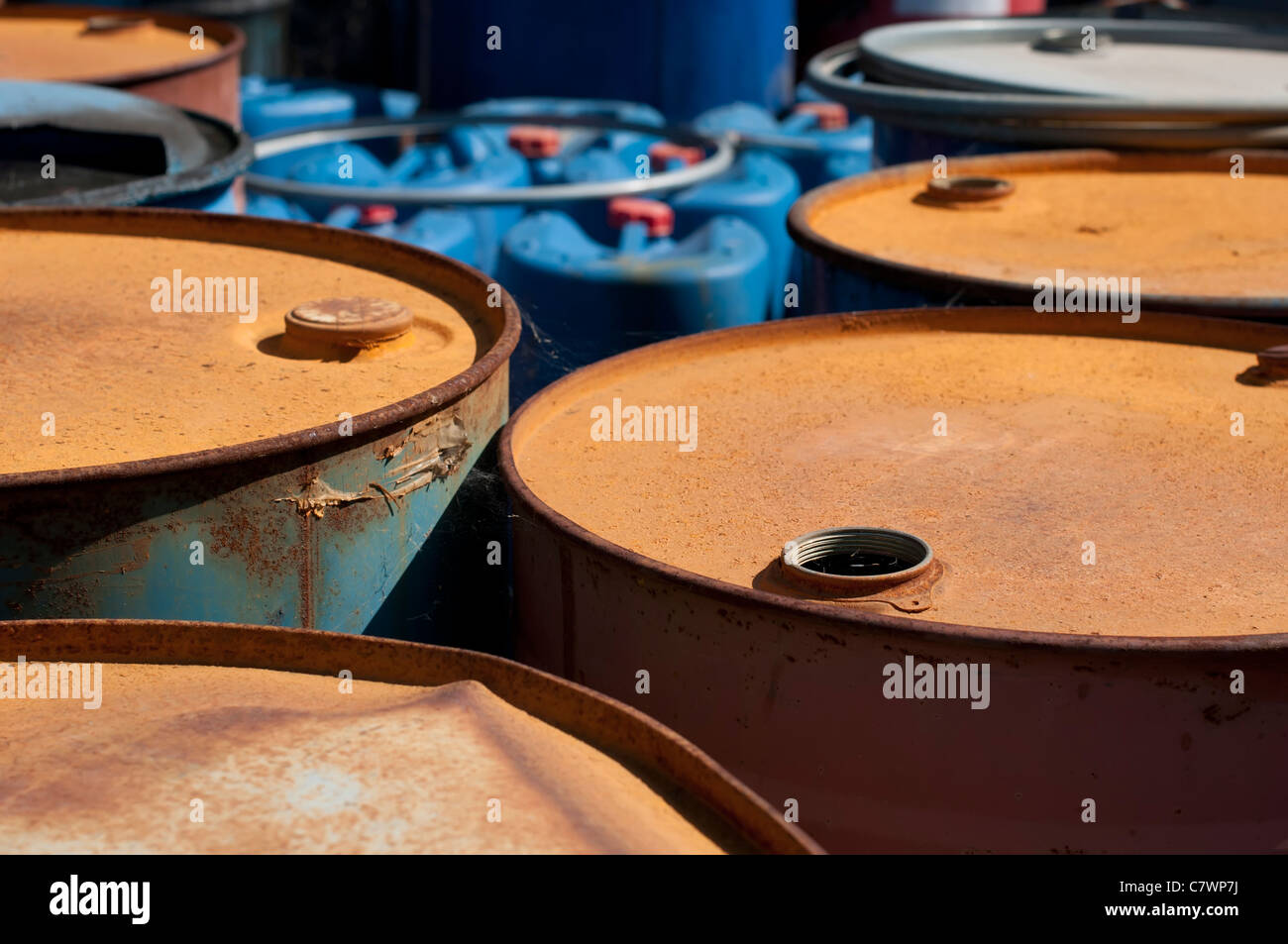 Old colored barrels for oil products. Empty rusted drums Stock Photo