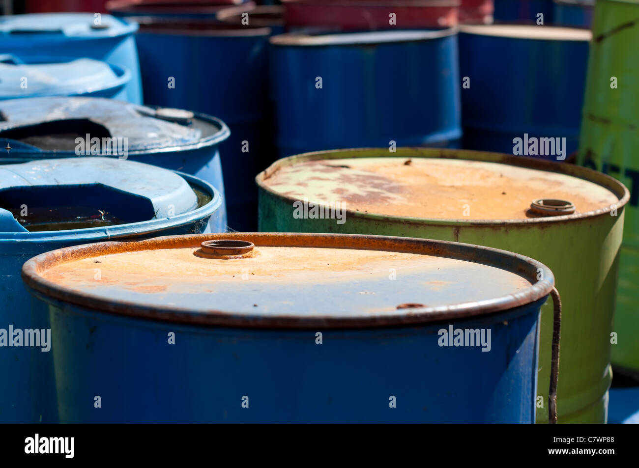 Old colored barrels for oil products. Empty rusted drums Stock Photo