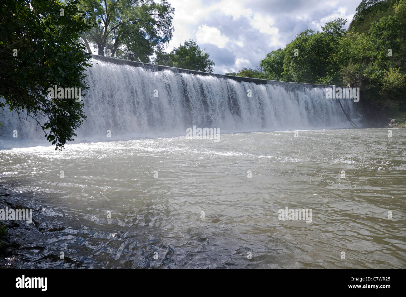 rushing waters at base of root river dam and waterfall in lanesboro