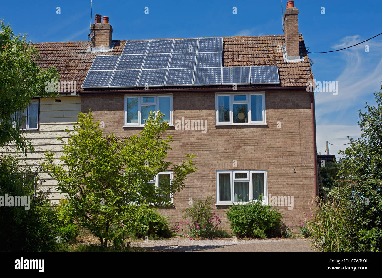 Former council house with solar energy panels Stock Photo Alamy
