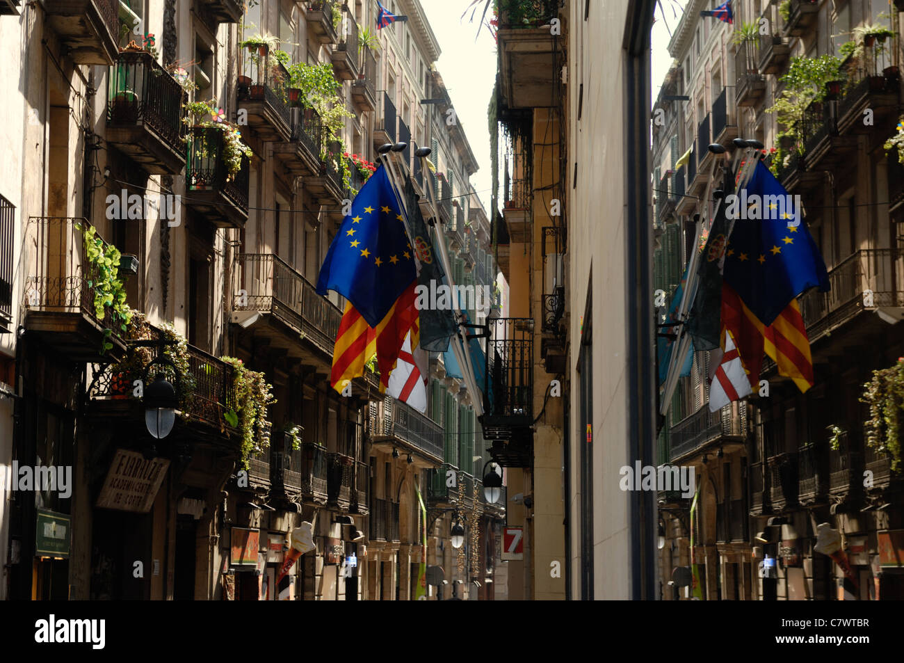 European flag flies alongside Catalan and St George cross flag in Barcelona,  Catalonia, Spain with reflections Stock Photo - Alamy