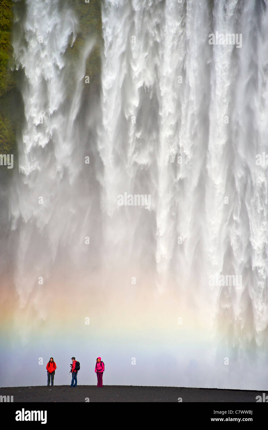 Tourists at the foot of Skogar waterfall in southwest Iceland. Stock Photo