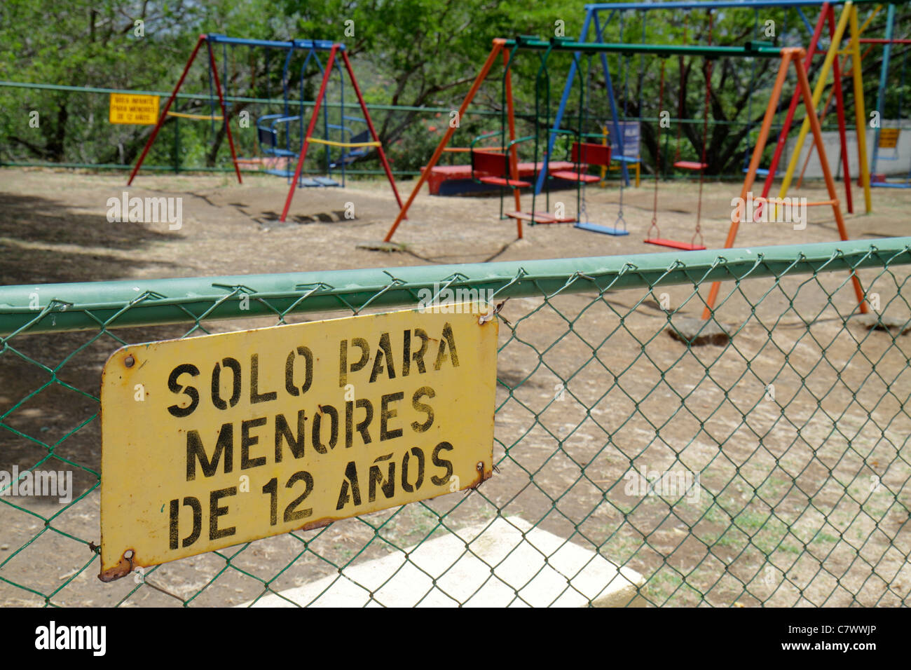 Managua Nicaragua,Loma de Tiscapa,national historic park,Parque historico,La Sombra de Sandino,playground,swings,fence,sign,Spanish,language,bilingual Stock Photo