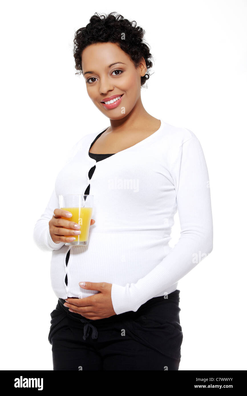 Pregnant woman holding a glass of orange juice , isolated on white ...