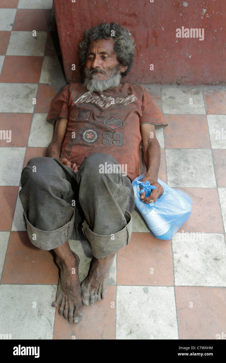 Granada Nicaragua,Central America,Calle Real Xalteva,vagrant,homeless,derelict,poverty,man men male adult adults,dirty,barefoot,grimy,lying on dirty f Stock Photo